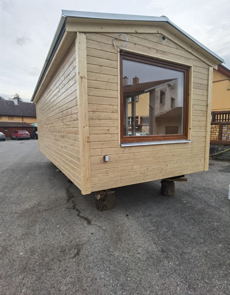 Dřevěný mobilní dům na podstavcích, venkovní pohled.